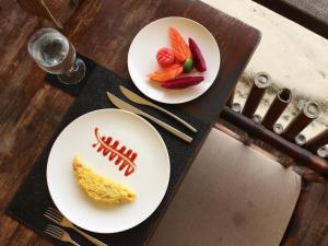 two white plates with food on top of a table at Jeeva Beloam Beach Camp in Tanjung Ringgit