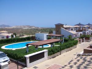 a view of a swimming pool and a picnic table at Villa Alandalus in Vera