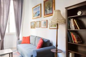 a living room with a blue couch and a lamp at Nobile Casa in Rome