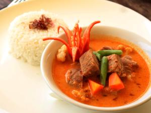 a bowl of soup and rice on a plate at Jeeva Beloam Beach Camp in Tanjung Ringgit