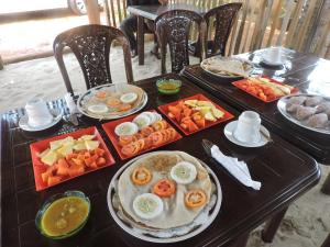 a table filled with food on top at Pleasant Park Holiday Inn in Trincomalee