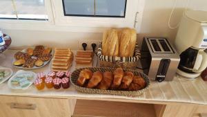 a table with a basket of bread and pastries at VillaFonzie Adults Only Gayfriendly in Montana la Data