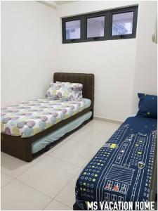 a bedroom with a bed and two windows at MS Vacation Home (Muslim Homestay) in Cameron Highlands