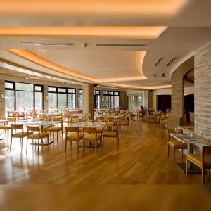 a restaurant with tables and chairs in a room at Miranda 514B 2br at Pico de Loro by Raquel's Place in Nasugbu