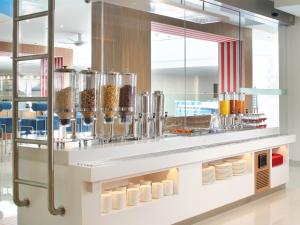 
a kitchen filled with lots of different types of drinks at Holiday Inn Express Baruna, an IHG Hotel in Kuta
