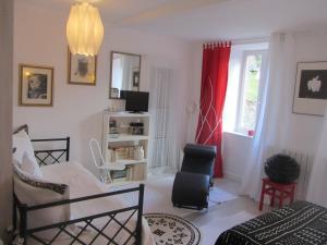 a living room with a bed and a window at La Maison de Natasha in Castillon-en-Couserans
