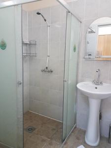 a bathroom with a shower and a sink at Sport Hotel in Slavyanka