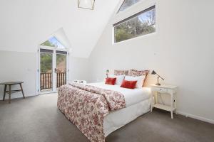 a white bedroom with a bed and two windows at Beyond Bliss - Guesthouse 1 in Bright