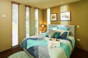 a bedroom with a large bed with two stuffed animals on it at No.6 - Luxury Private Haven in the Heart of Bright in Bright