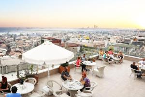a patio area with tables, chairs and umbrellas at Benler Otel Laleli ISTanbul in Istanbul