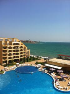 a view of a resort with a swimming pool and the ocean at Grand Midia Resort, Sky level apartments in Aheloy