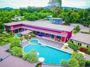 an aerial view of a house with a swimming pool at The Canal Garden Resort in Ban Huai Sua