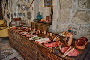 a buffet of food on a table in a room at Emit Sakura Cave Hotel in Göreme