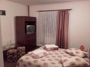 Кровать или кровати в номере Pension Piatra Craiului