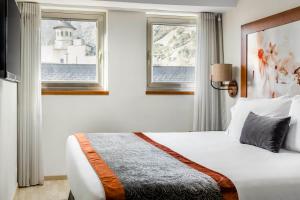 a hotel room with a bed and a window at Eurostars Andorra in Andorra la Vella
