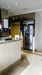 a drink station in a mall with a vending machine at Santa Clara in Oviedo +27 photos