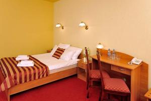 Postel nebo postele na pokoji v ubytování Hotel Na Błoniach