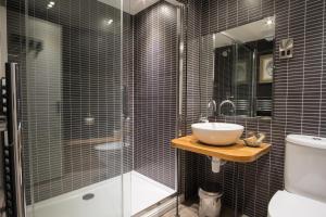 a bathroom with a sink and a glass shower at Royal Oak at Keswick in Keswick