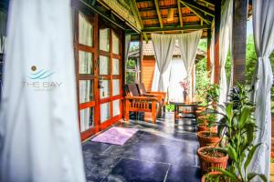 a screened in porch of a house with plants at The Bay Agonda in Agonda