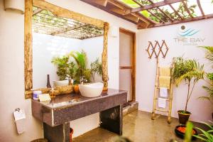 a bathroom with two sinks and a mirror at The Bay Agonda in Agonda +30 photos