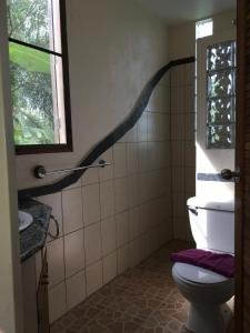 a bathroom with a toilet and a window at Lake View Bungalows in Khao Lak