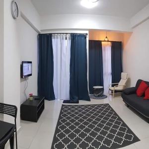 a living room with blue curtains and a couch at MS Vacation Home (Muslim Homestay) in Cameron Highlands