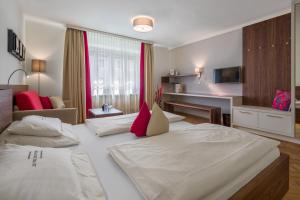 
Ein Bett oder Betten in einem Zimmer der Unterkunft Hotel Rosenvilla
