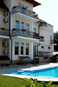 a house with a swimming pool in front of it at Edem Hotel in Chişinău