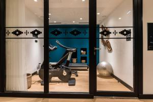 a room with a gym with a exercise bike at Laz' Hotel Spa Urbain Paris in Paris