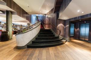 a staircase leading up to a large room with a staircase leading up to a at Malmaison Manchester in Manchester