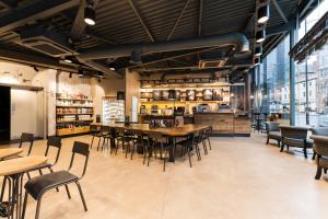 a restaurant with tables and chairs and a bar at Malmaison Manchester in Manchester