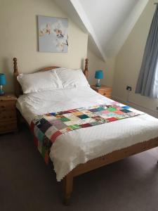 a bedroom with a bed with a quilt on it at The Swallow Hotel in Bridlington