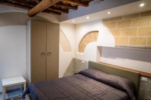 מיטה או מיטות בחדר ב-Cortile Azzurro