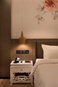 Postel nebo postele na pokoji v ubytování Paco Hotel Dongpu Guanghzou -Free Shuttle Bus for Canton Fair