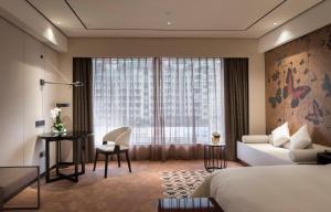 Postel nebo postele na pokoji v ubytování Paco Hotel Dongpu Guanghzou -Free Shuttle Bus for Canton Fair