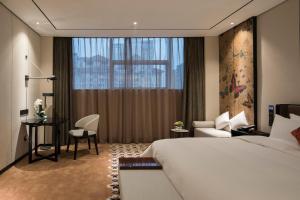 Postel nebo postele na pokoji v ubytování Paco Hotel Dongpu Guanghzou -Free Shuttle Bus for Canton Fair