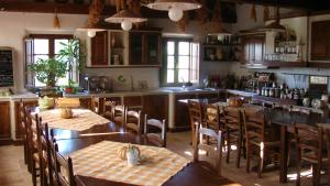 a kitchen with two tables and chairs and a counter at Agriturismo Terra Sabina in Poggio Mirteto