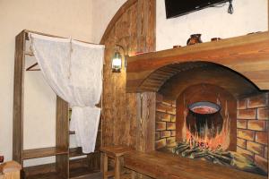 a fireplace in a living room with at Gostiniy Dvor in Mineralnie Vody