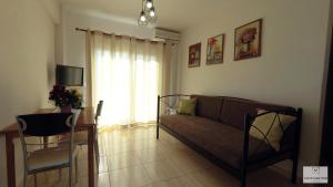 a living room with a couch and a table at Aliveri Residence Apartments in Aliveri