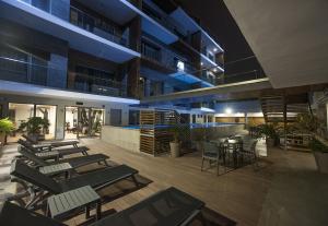 a building with a patio with tables and chairs at Ocean Park Appart Hotel in Casablanca