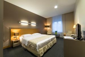 Postel nebo postele na pokoji v ubytování Hotel-Résidence Am Klouschter