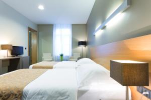 Postel nebo postele na pokoji v ubytování Hotel-Résidence Am Klouschter