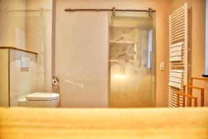 a bathroom with a toilet and a glass shower at Flair Hotel Nieder in Bestwig