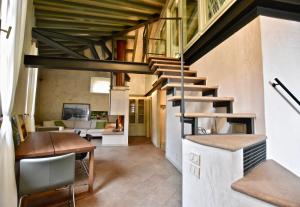 a living room with a staircase in a house at Via Sambuco in Iseo