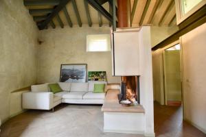 a living room with a white couch and a fireplace at Via Sambuco in Iseo