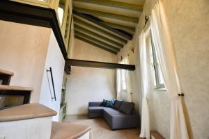 a living room with a couch and a ceiling at Via Sambuco in Iseo