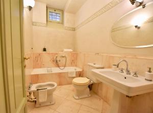 a bathroom with a sink toilet and a mirror at Via Sambuco in Iseo +29 photos