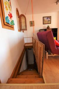 a stairway in a room with a red couch at Valle y Mar, Casa de Huéspedes in La Herradura