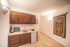 a kitchen with wooden cabinets and a counter top at Luxury Villa Caretta in Kaş