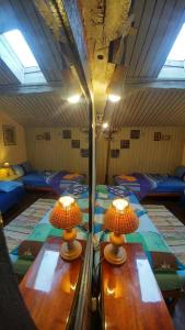 two lamps on tables in a room with beds at Rooster Hostel in Veliko Tŭrnovo